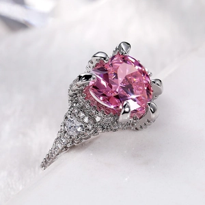 Macro shot of luxury heart-shaped pink zircon ring with pavé setting and filigree details