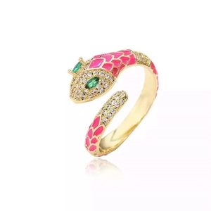 Macro view of gold snake ring with pink enamel details and inlaid green gemstones