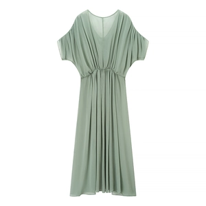 Detail of sage green maxi dress featuring a deep V-neckline and high-waisted pleated design