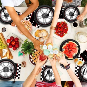 Racing party placemat with tire shape and checkered flag border on a dining table