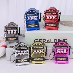 Mini slot machine keychains in six metallic colors shown on a bright white desk