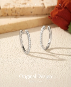 Detailed close-up of S925 sterling silver stamp on moissanite hoop earrings
