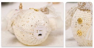 Detail of the glowing Christmas snowman doll showing the battery compartment and golden buttons