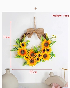 Detail of 30cm artificial sunflower wreath with green leaves and rustic hemp bow