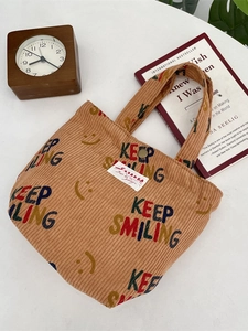 Brown corduroy tote bag with Keep Smiling print and magnetic closure for casual use