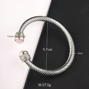 Detail showing cable twist bangle dimensions 5.7cm diameter and pink gemstone inlay