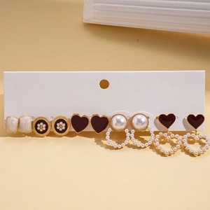 Detail view of 6-pair earring set featuring pearls, hearts and floral oil-drop designs