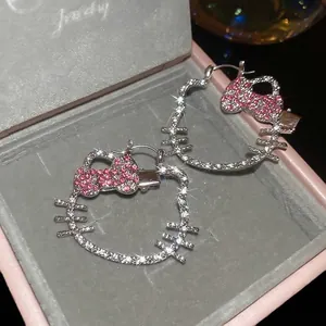 Sparkling silver hollow Hello Kitty earrings with pink rhinestones in a luxury jewelry box
