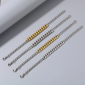 Close-up of silver and gold two-tone Cuban link bracelets with secure lobster clasps