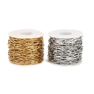 Bulk 18k gold plated and stainless steel oval cross chains on white spool rollers