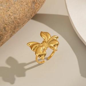Detailed view of the intricate golden butterfly ring with adjustable open band design