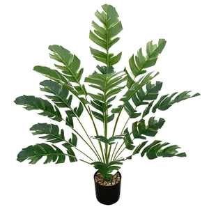 Artificial variegated traveler's palm tree in a black pot for home decor