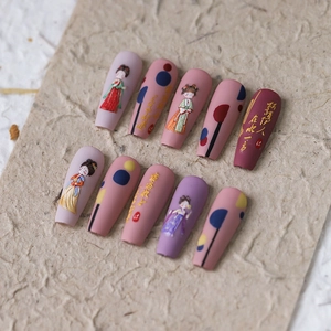 Oriental style press-on nails with lady illustrations and gold calligraphy on long coffin shape
