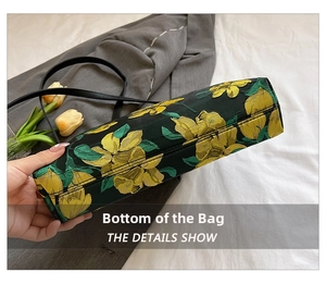 Detail of reinforced rectangular base with fine stitching on floral embroidery handbag