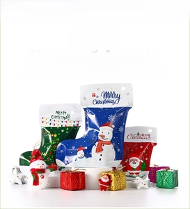 Detail of Christmas stocking shaped stand-up pouches with snowman and Santa patterns