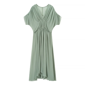 Detail of light green V-neck dress featuring elegant pleated waist and batwing sleeves