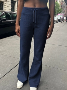 Outdoor shot of deep blue straight-leg yoga pants with an adjustable drawstring waist