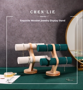 Detail of solid wood jewelry stand with dark green velvet bar for bracelets and watches