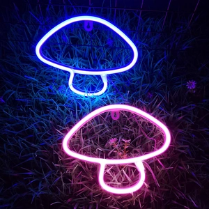 Blue and pink mushroom LED neon signs glowing on grass background for wall decor