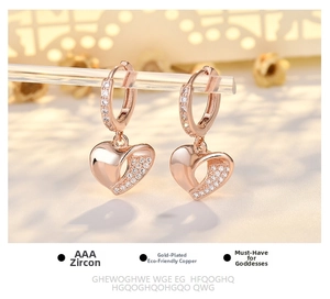 Macro shot of rose gold heart earrings with AAA cubic zirconia inlays on acrylic stand