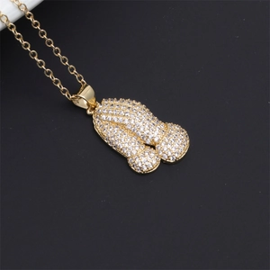 Macro view of gold pendant necklace featuring full pavé rhinestones on unique design