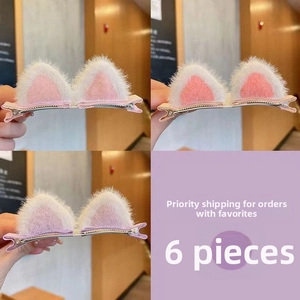 Detail of plush cat ear hair clips with pink inner lining and metal alligator clip base
