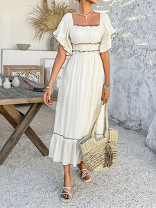 Detail view of white linen dress featuring square neck, ruffled sleeves and black piping
