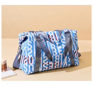 Close-up of blue travel bag with repeated business pattern and grey adjustable straps