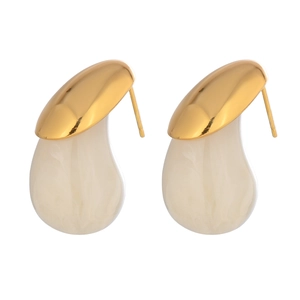 Detailed view of gold metal studs with milky white marble textured teardrop pendants