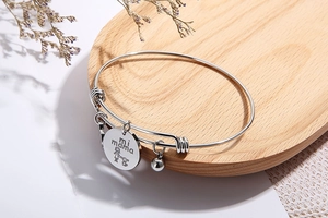 Detailed view of adjustable silver titanium bracelet with mi mama engraved pendant