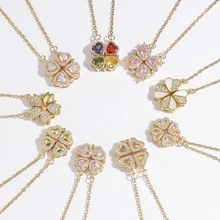 Detail of colorful clover heart necklaces with foldable magnetic pendants in gold finish