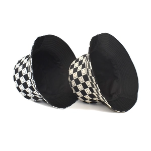 Detail of checkered bucket hat with smiley face print and high-quality cotton texture