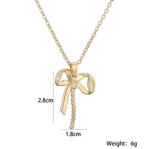 Detail shot of gold-plated bow necklace with cubic zirconia measurements 2.8cm by 1.8cm