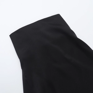 Detailed macro shot of high-quality black matte fabric texture on a slim-fit dress waist