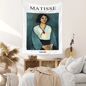 Artistic Henri Matisse tapestry displayed on a cozy bedroom wall with wooden furniture