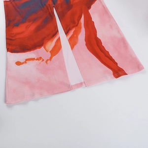 Close-up detail of artistic tie-dye pattern and stitching on wide-leg trousers