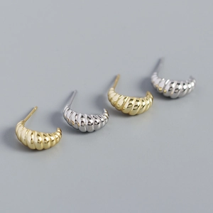 Detail view of s925 silver croissant earrings with gold and silver striped metallic textures