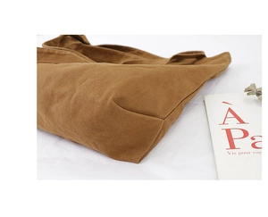 Detailed macro view showing the thick brown canvas texture and durable bottom of the tote