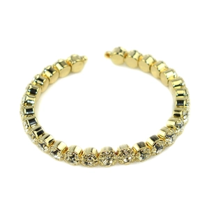 Elegant gold plated open bangle bracelet with a continuous row of sparkling round crystals