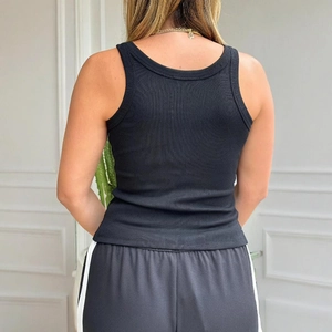 Close-up of black ribbed knit tank top featuring a deep U-shaped back and soft texture