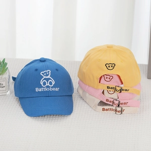 Detail of colorful cotton toddler baseball caps with bear embroidery and metal buckle