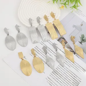 Detailed view of gold and silver liquid lava earrings with brushed geometric textures