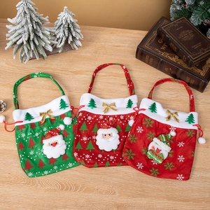 Three festive Santa and Snowman gift bags with handles on a rustic wooden table background