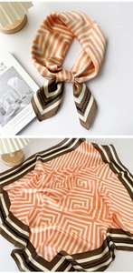 Close-up of elegant geometric pattern silk scarf with orange and brown maze textures