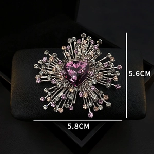 Detailed view of luxury heart-shaped emerald crystal brooch with dimension markings