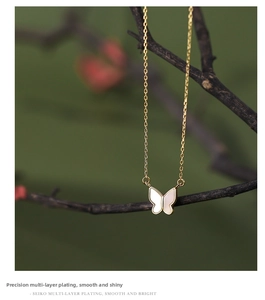 Detailed macro view of S925 silver butterfly pendant with white mother-of-pearl inlay