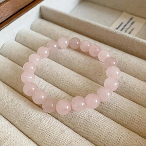 Detail of pink strawberry crystal beaded bracelet displayed on a premium jewelry tray