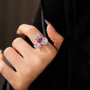 Close-up of vintage zircon clover ring with pink gemstones on model hand