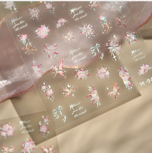 Detail of holographic laser nail stickers with butterfly and flower patterns on silk