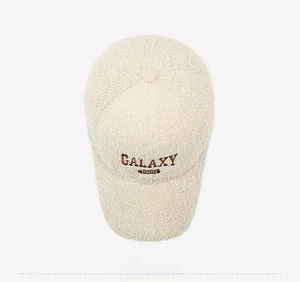 Detailed close-up of cream faux shearling baseball cap with Galaxy 1998 brown embroidery
